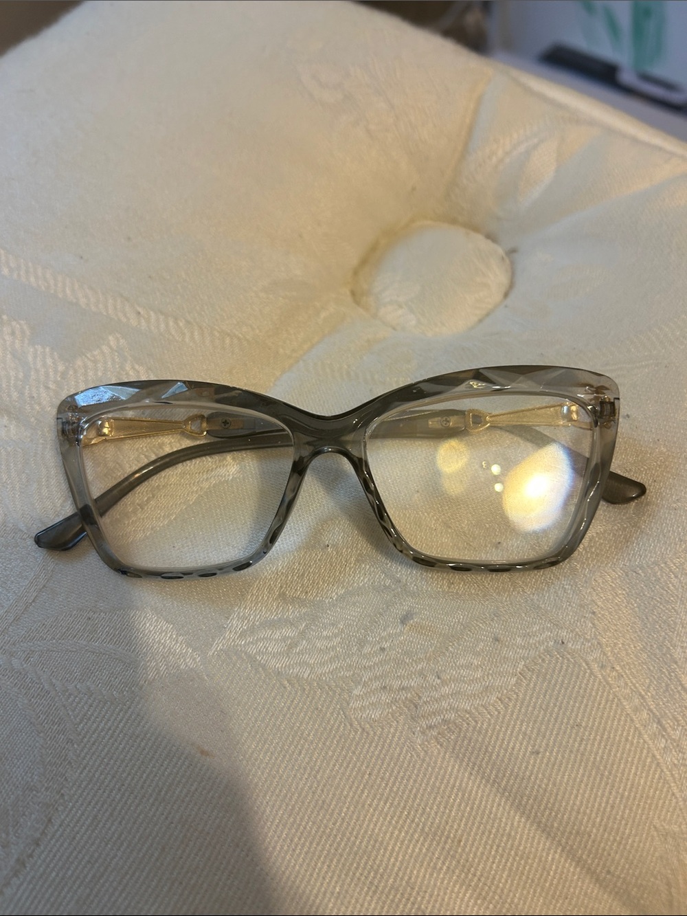Cat-eye reading glasses with a clear tinted frame
